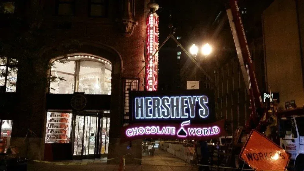 Hershey's Chocolate World store at night with a lit-up sign, New York City.