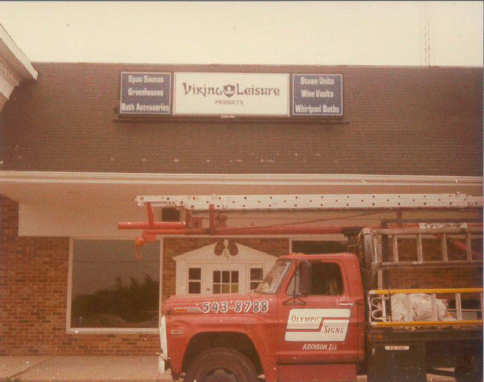 Red truck with ladder parked outside Viking Leisure Projects building.