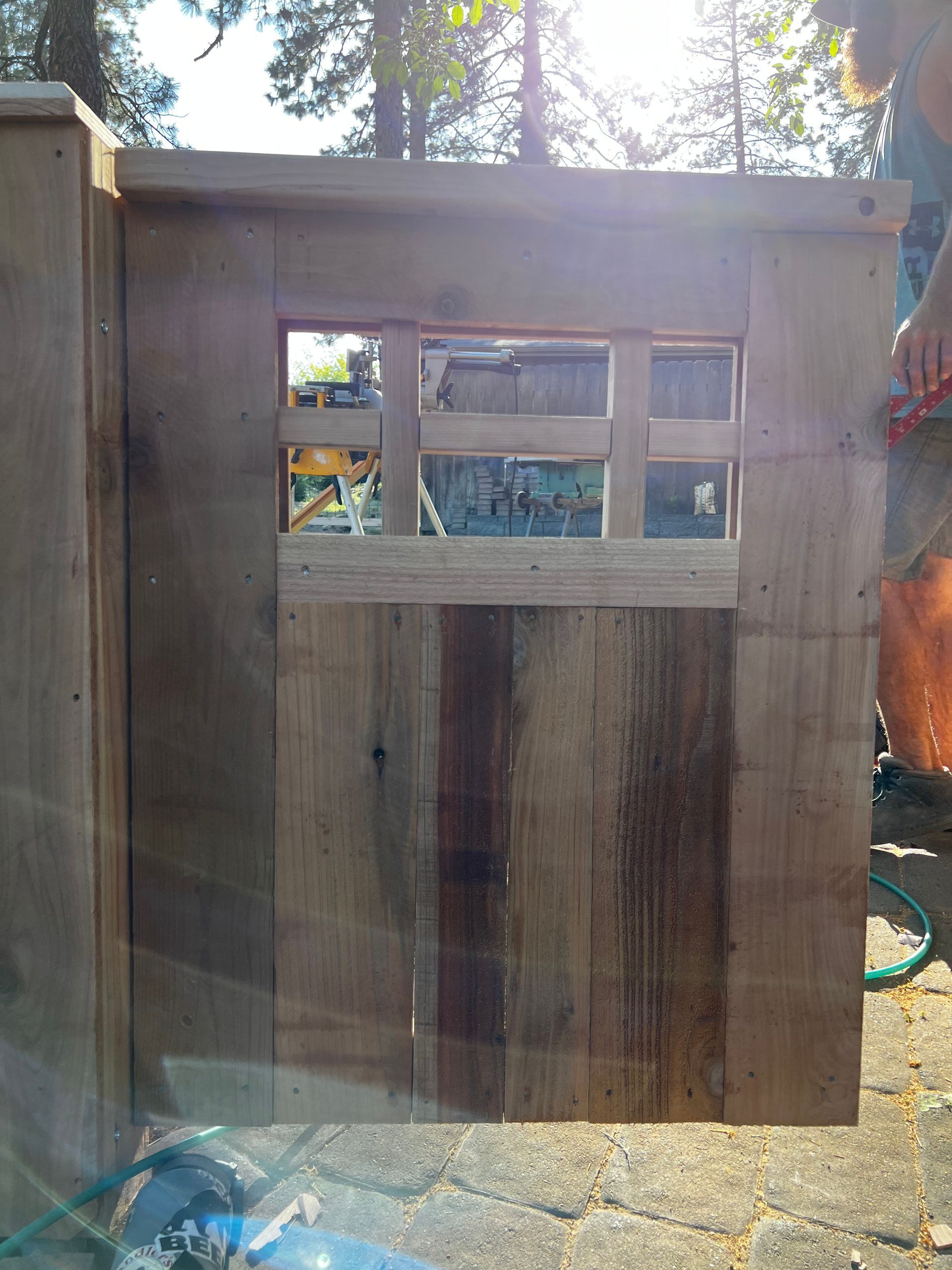 A wooden door with a window in the middle of it.