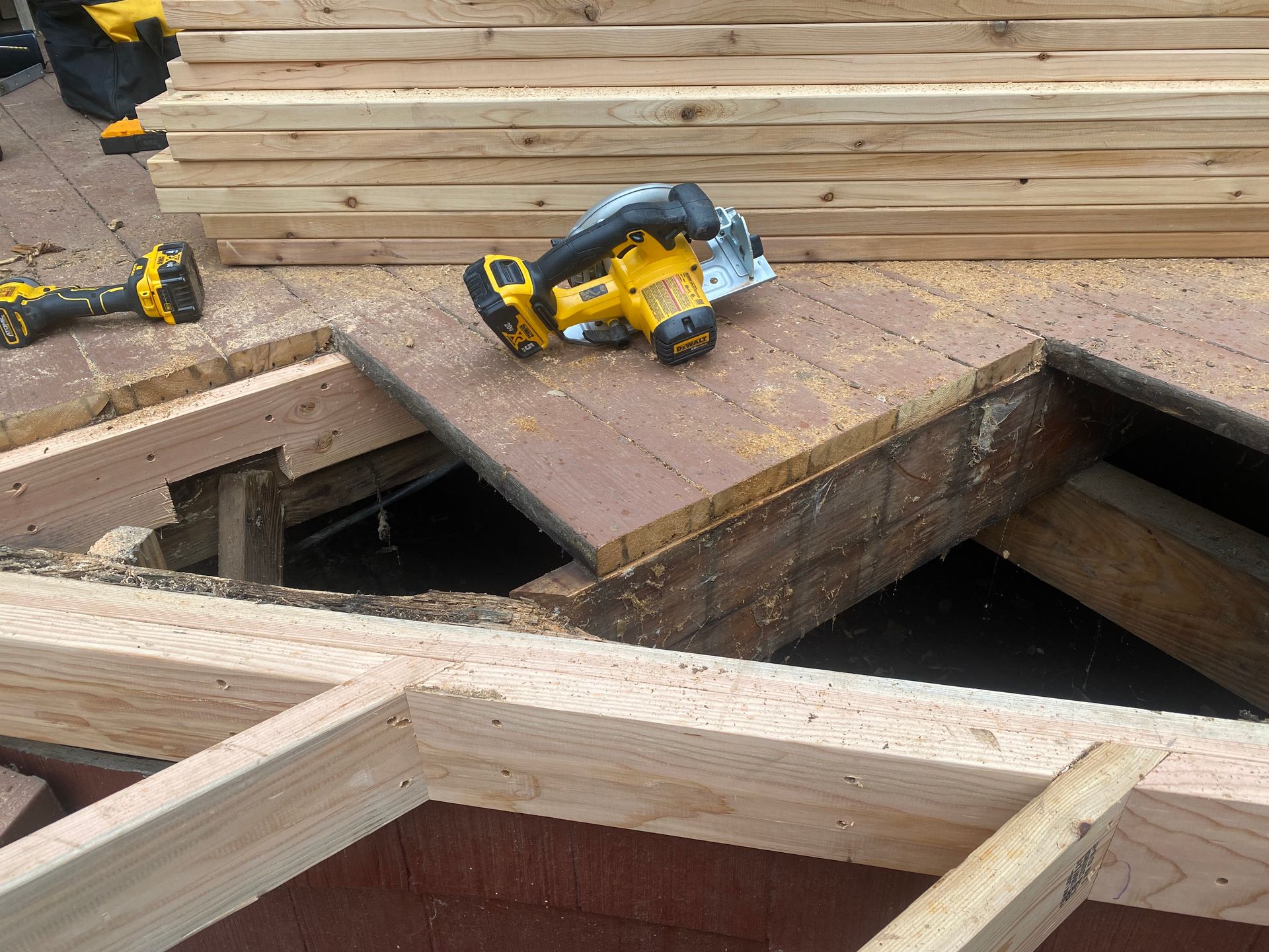 A circular saw is sitting on top of a wooden table.