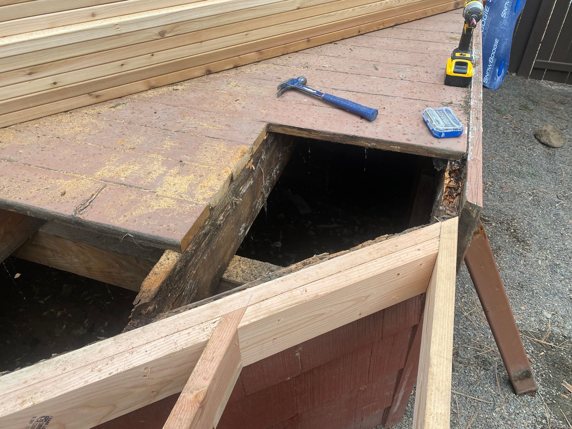 A hammer is sitting on top of a wooden table.