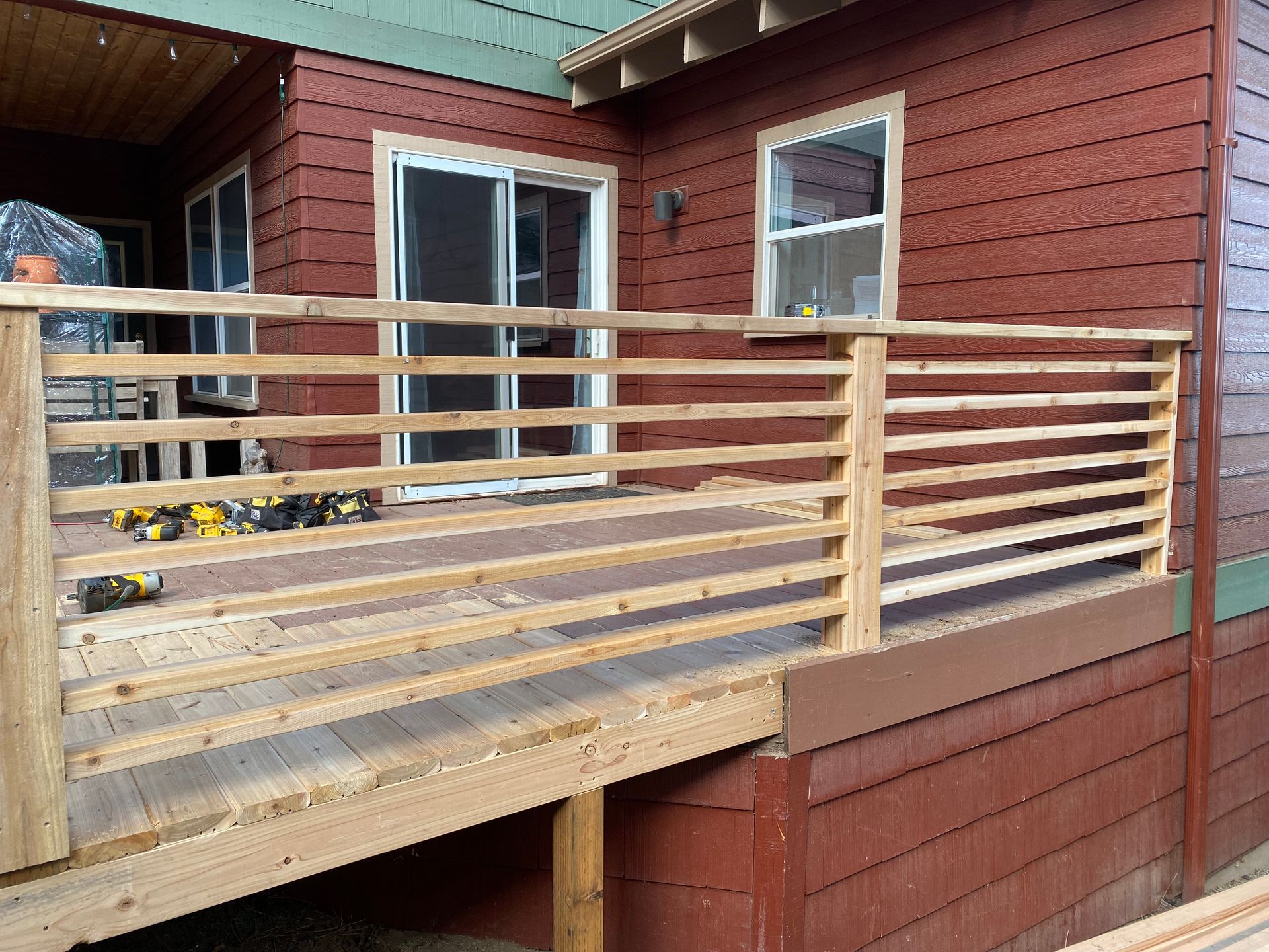 A wooden deck is being built on the side of a house