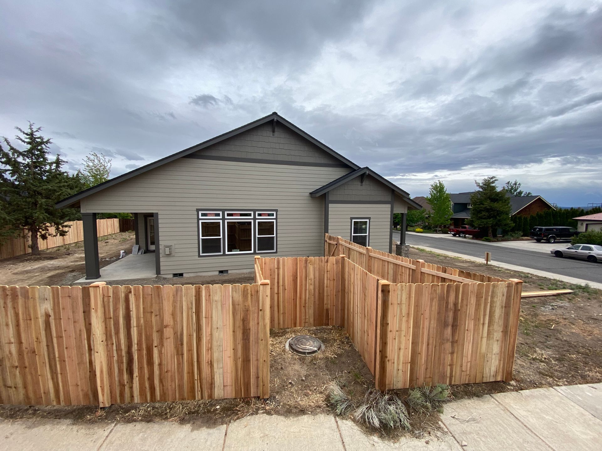 A house with a wooden fence in front of it.