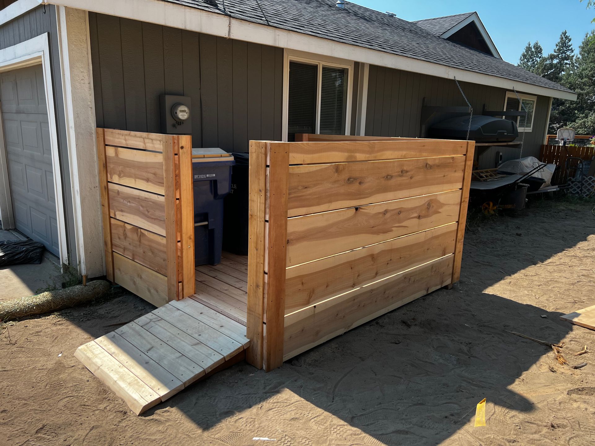 A wooden fence with a ramp in front of a house