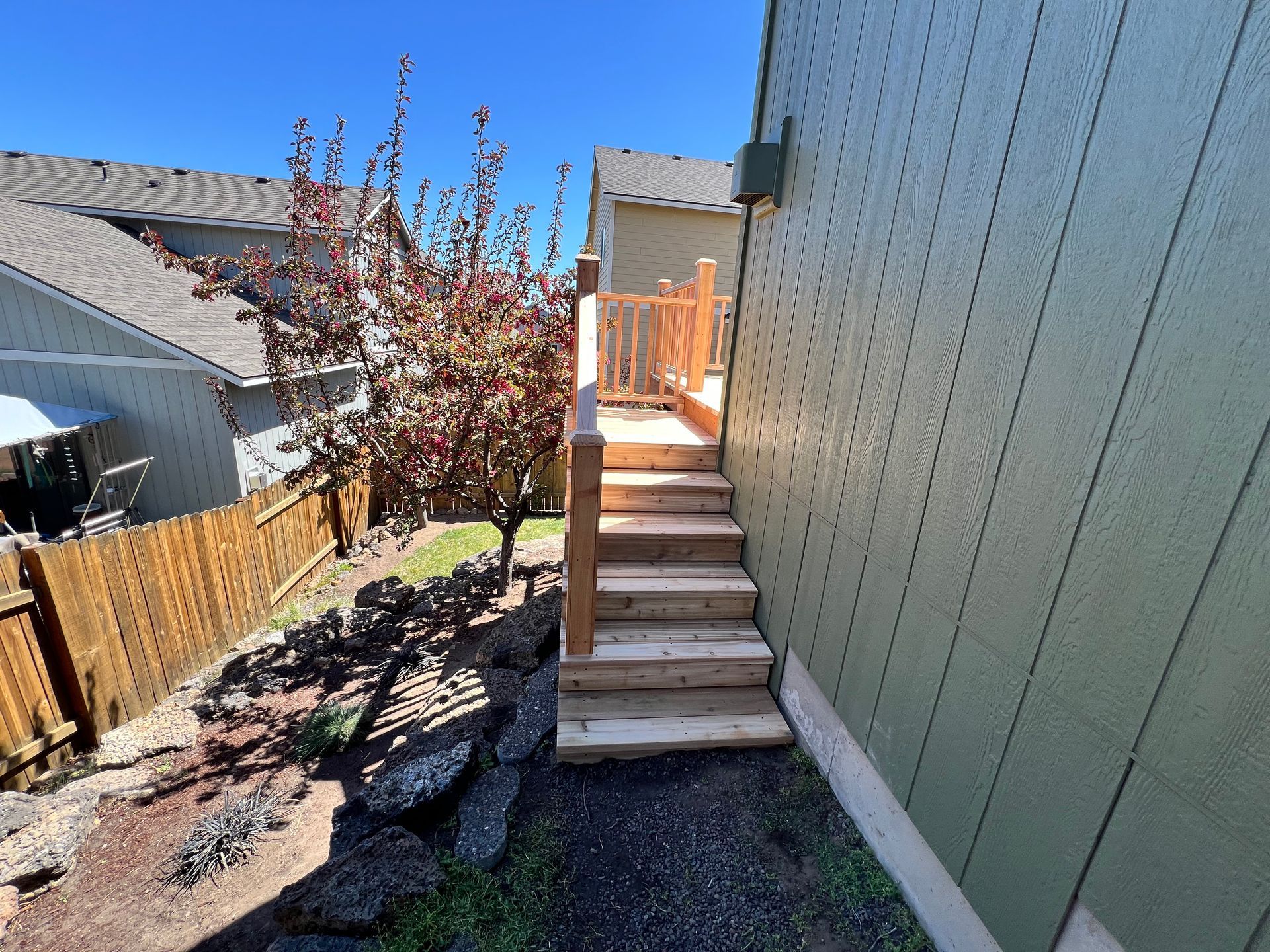 A house with a wooden deck and stairs leading up to it