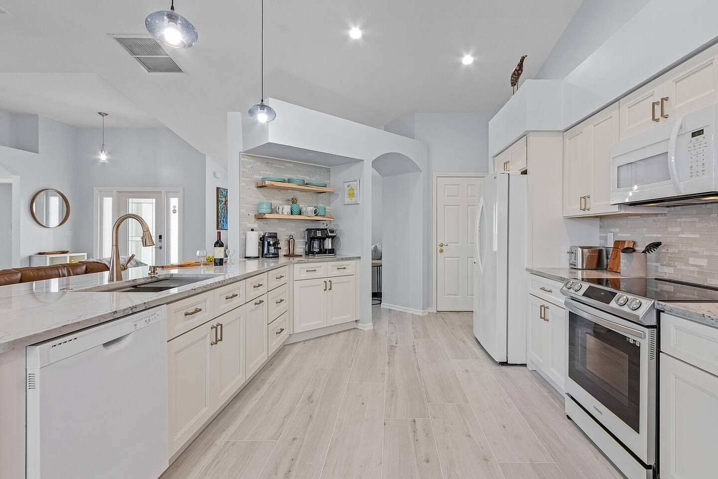 Image of a homeowner's kitchen after a recent renovation. All white walls & cabinets.