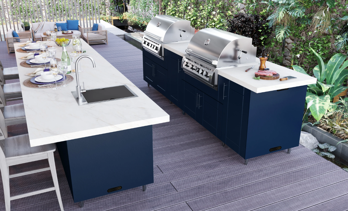 Image of a WeatherStrong outdoor kitchen set with blue cabinets & white countertop with a couple of grills and sink.