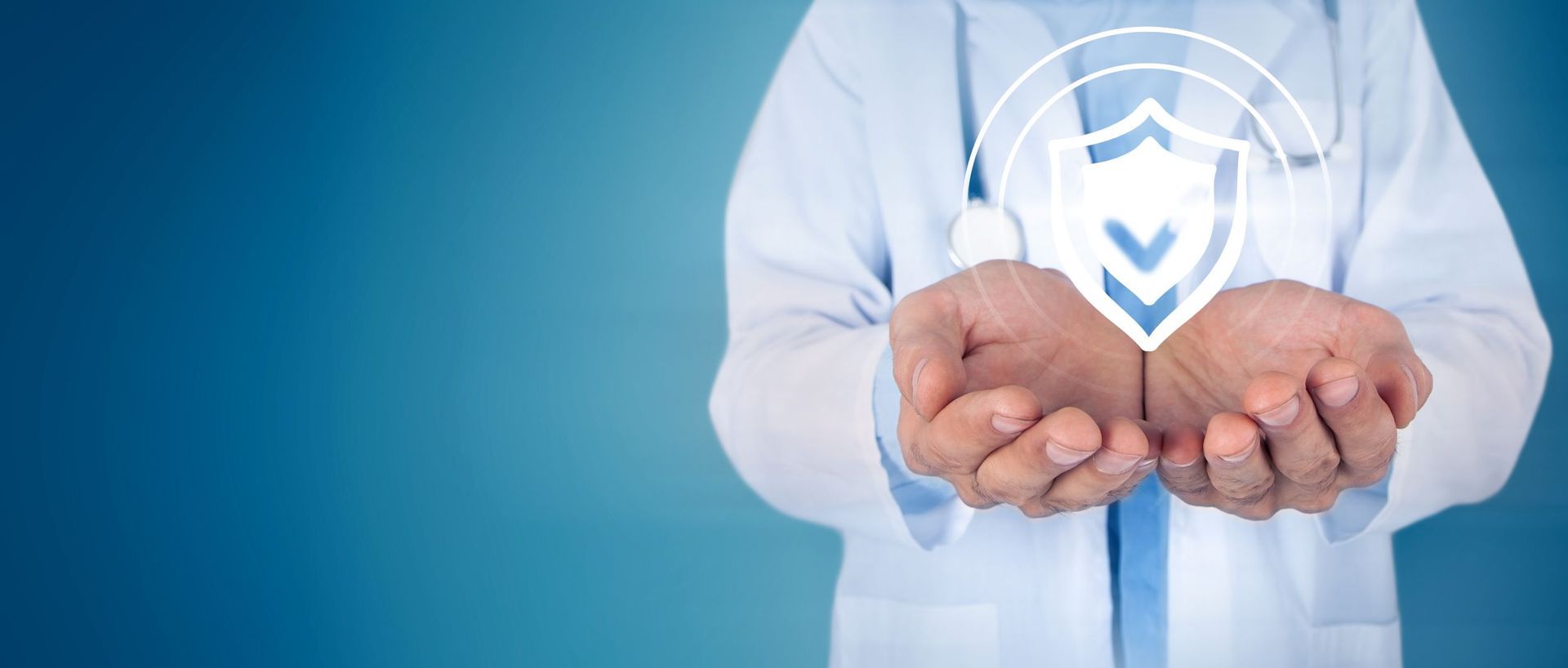 Medical person in blue gloves holding a glass earth globe with a plaster across it