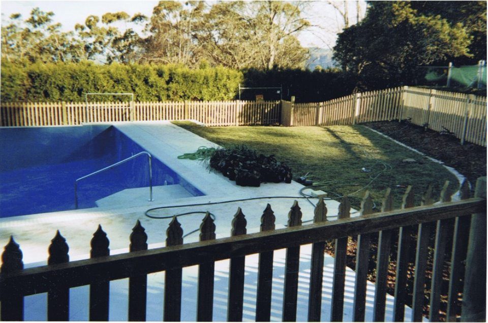 view of a pool with wooden fence