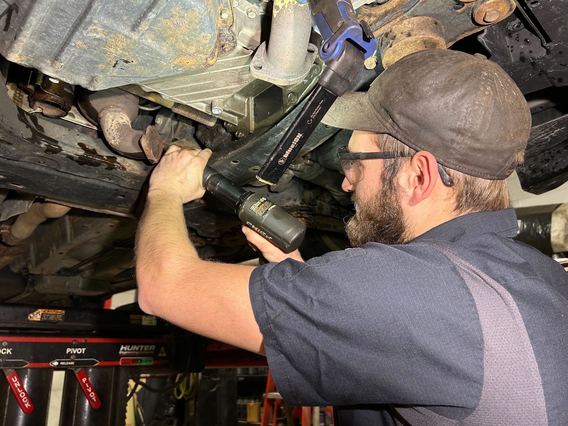 ASE certified mechanic working on a customer's car who is from Lenox Township.