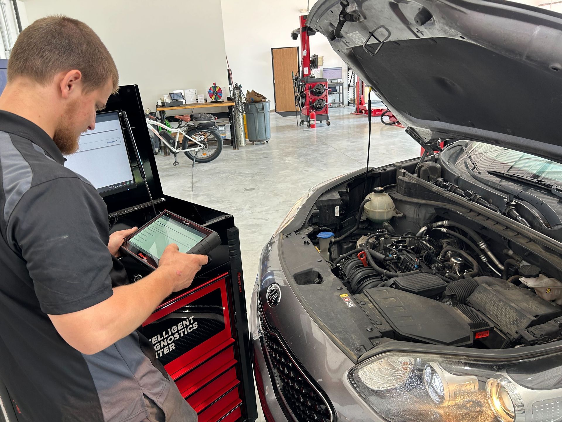 A mechanic wearing goggles is using a torch on a car part from a customer that lives in . China Township, Michigan.