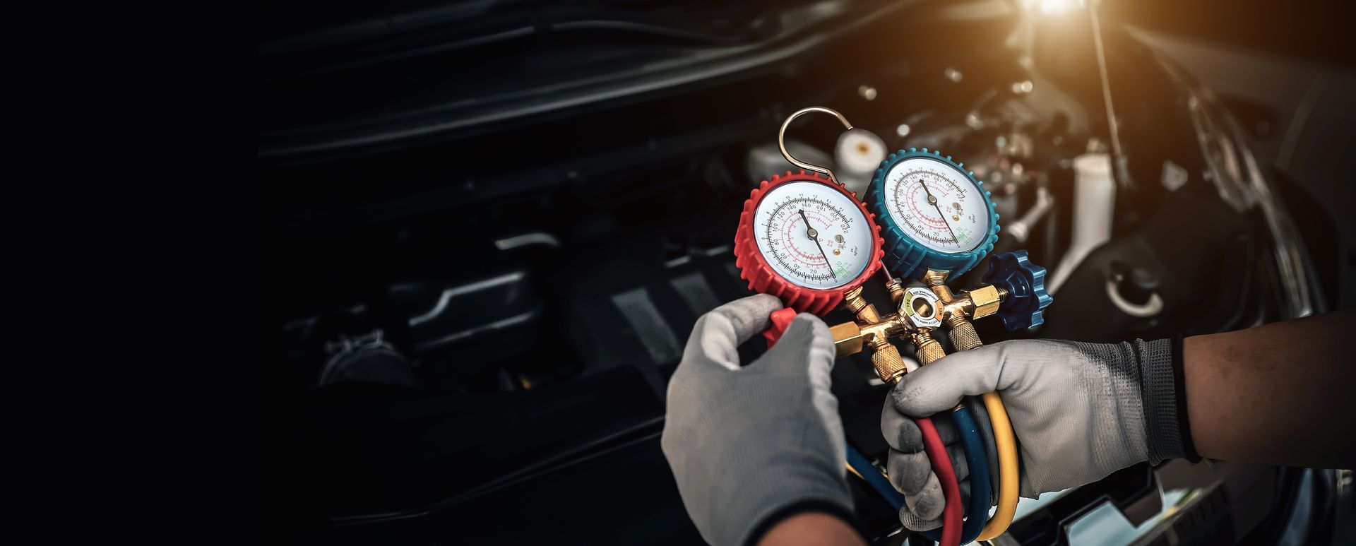 A technician testing the AC system on a customer's car who was having issues with their AC.