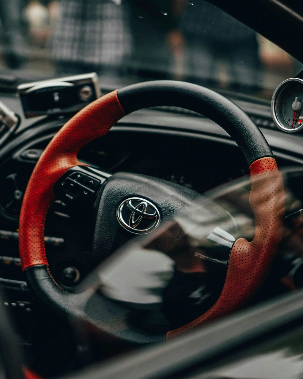 A Close-up Of A Black And Orange Steering Wheel On A Toyota Vehicle Brought Into Auto Dr For Repairs.