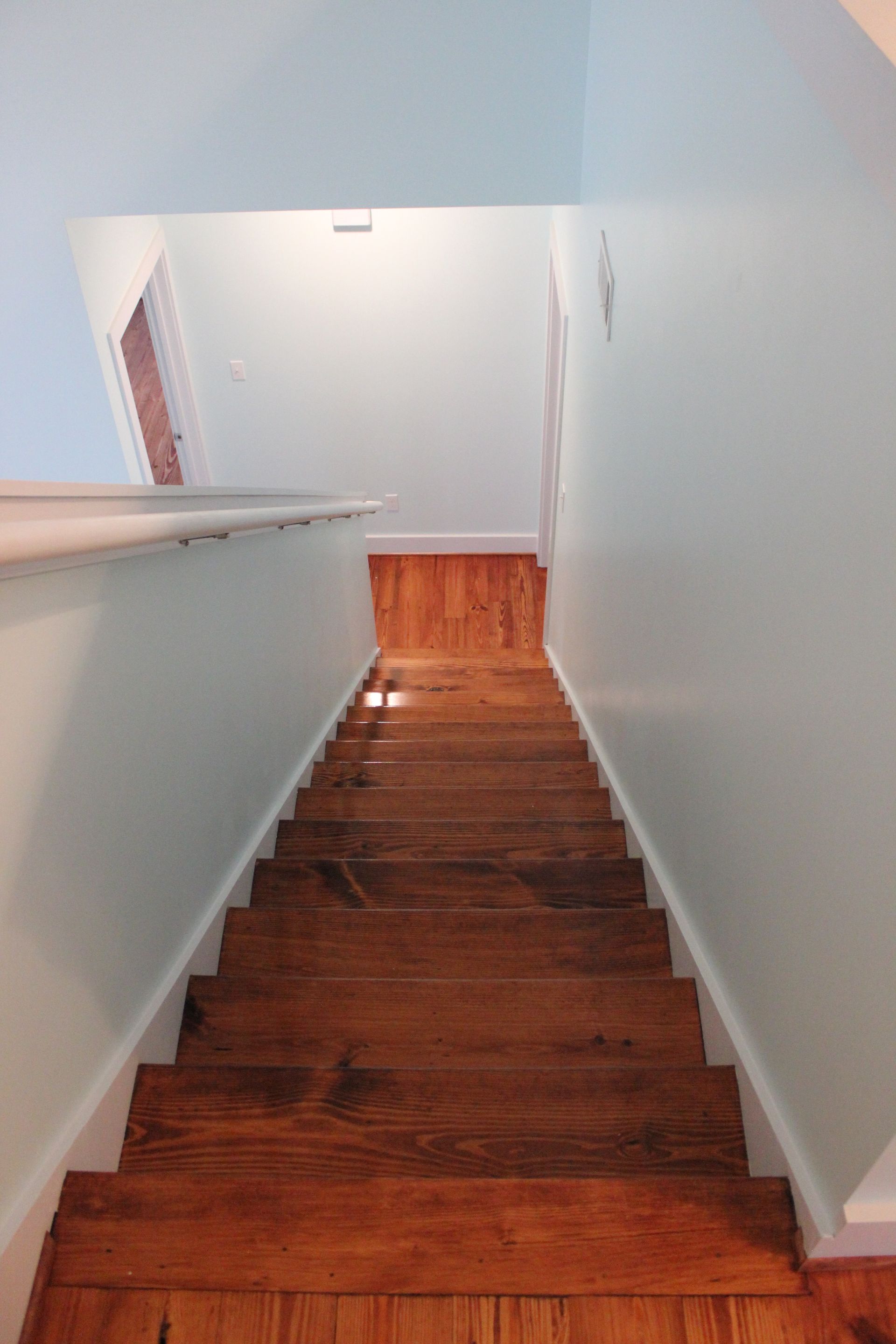 A wooden staircase leading up to the second floor of a house.