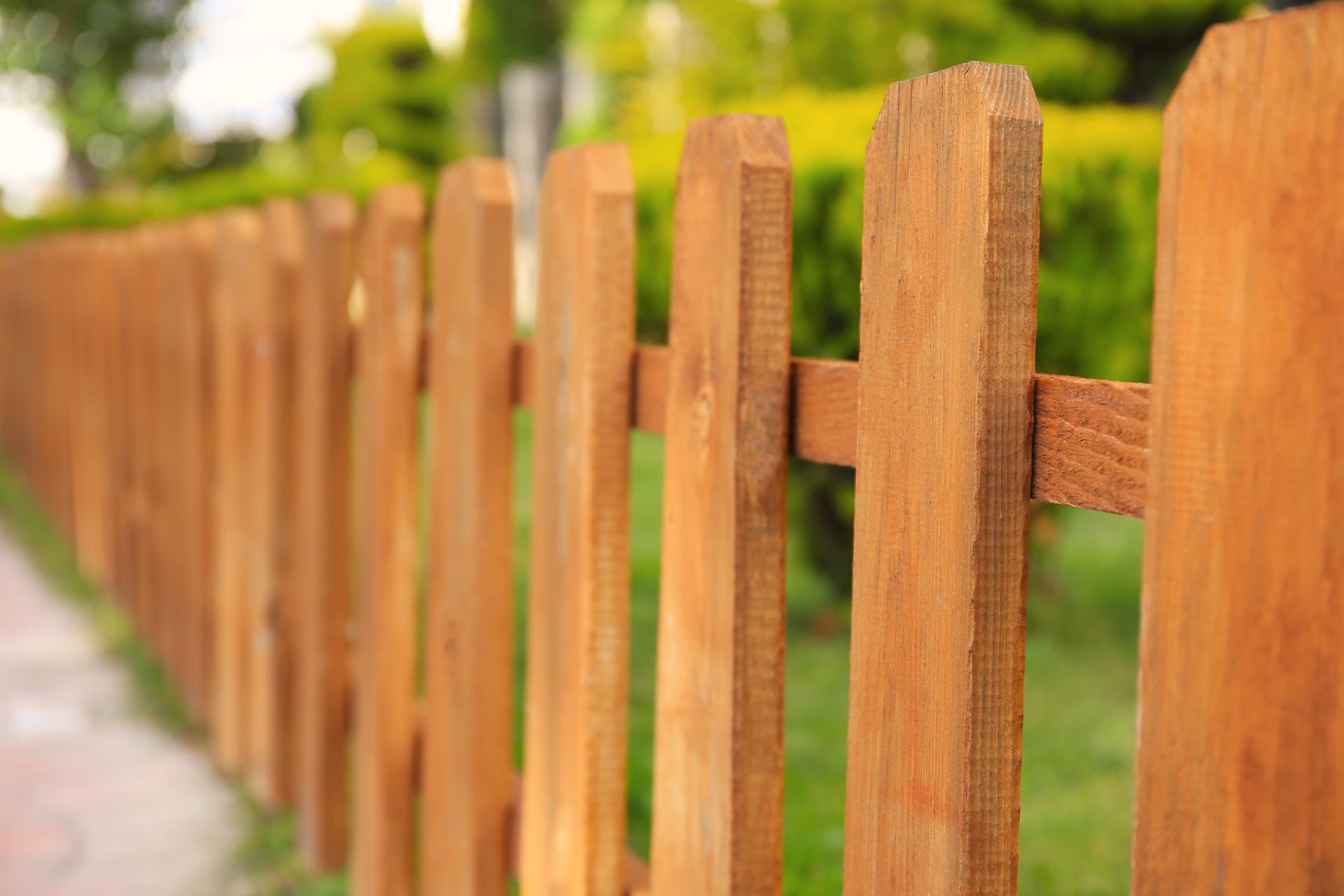 Wood privacy fence installation in Springfield MO backyard with natural wood posts and rails