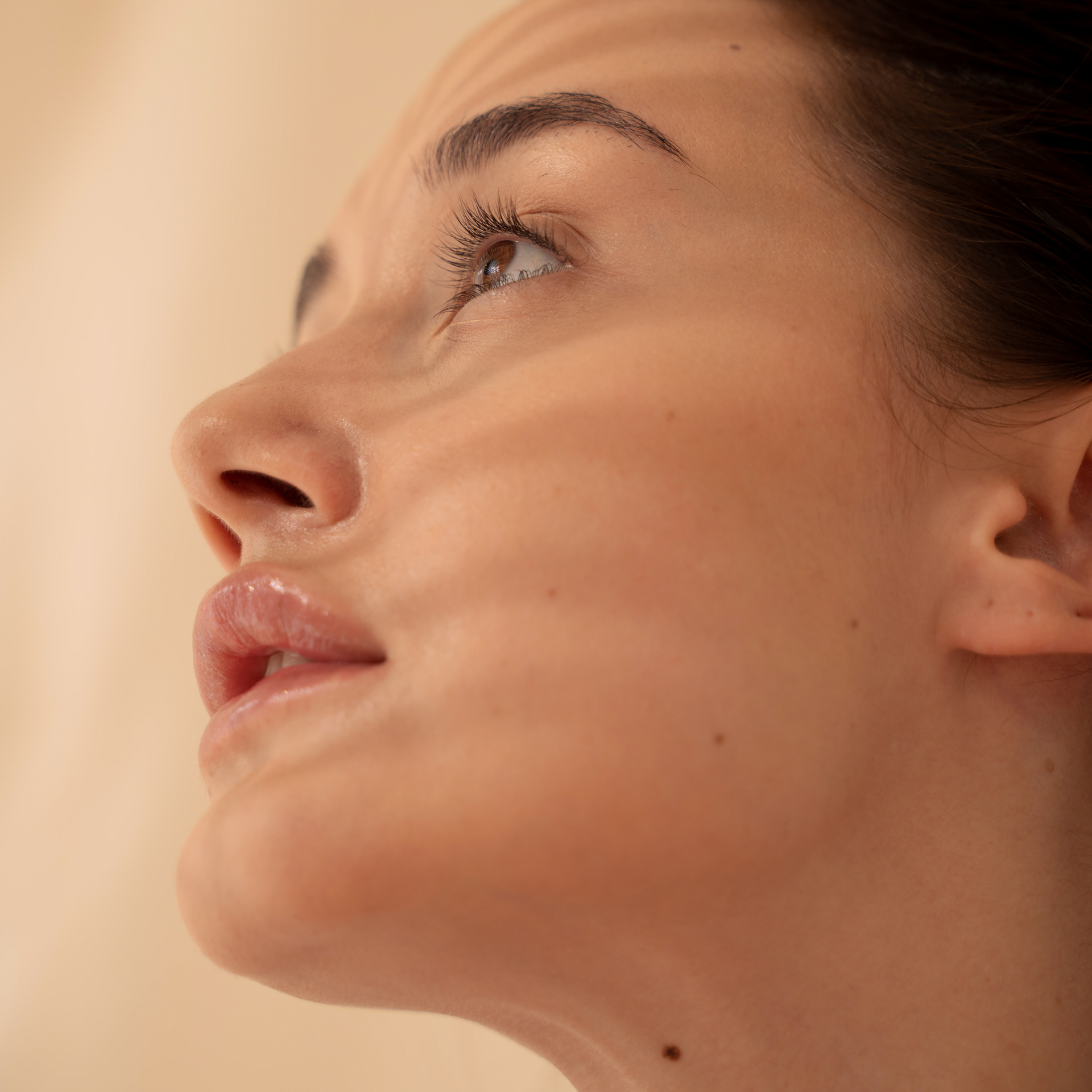 A close up of a woman 's face looking up.