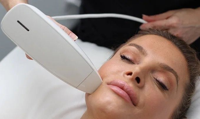 A close up of a woman 's face with her eyes closed.
