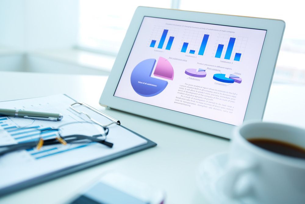 A Tablet With A Graph On It Is On A Desk Next To A Cup Of Coffee — Visionary Accounting In Parkes, NSW