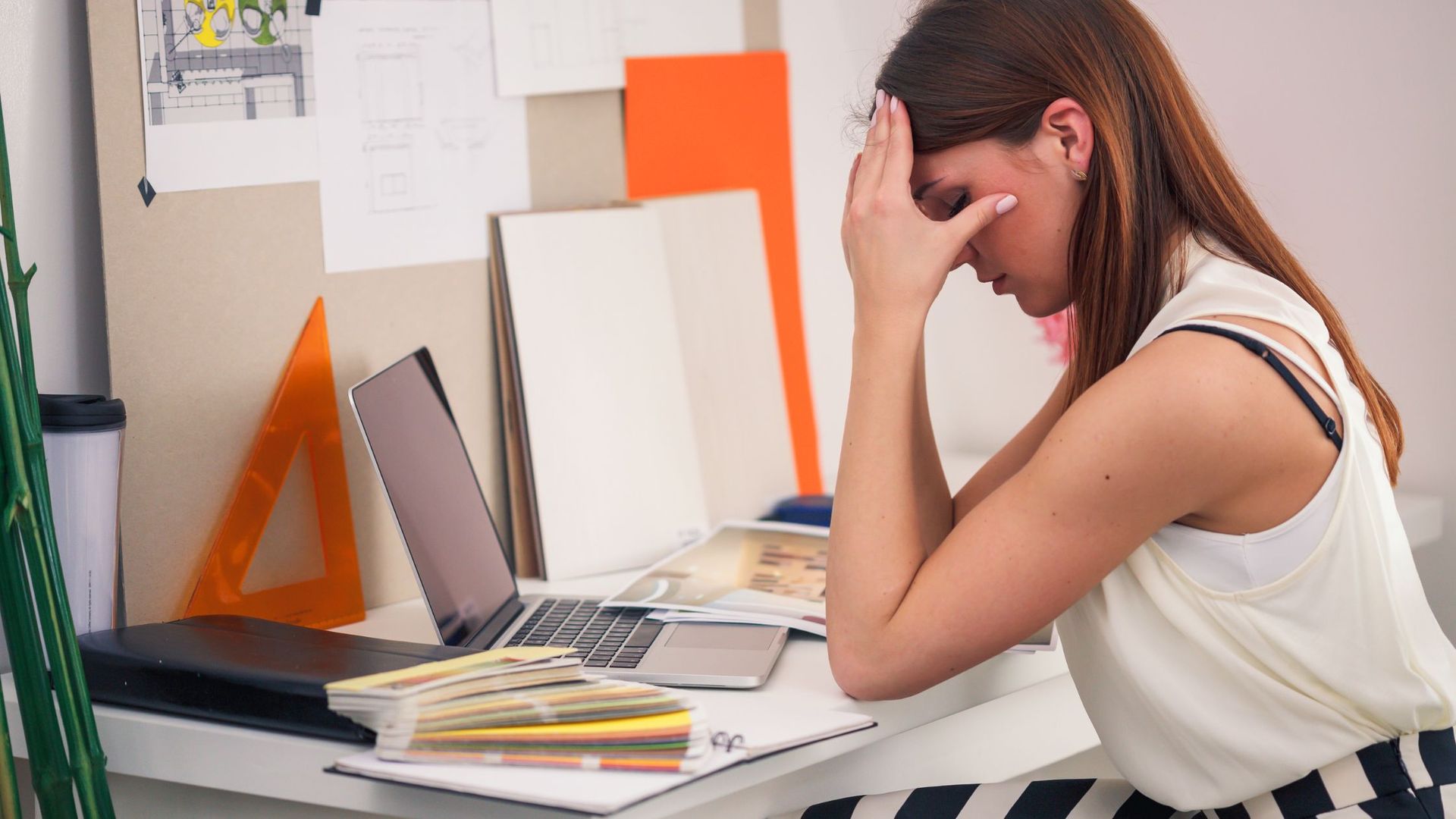 Woman stressed over work sitting at desk
