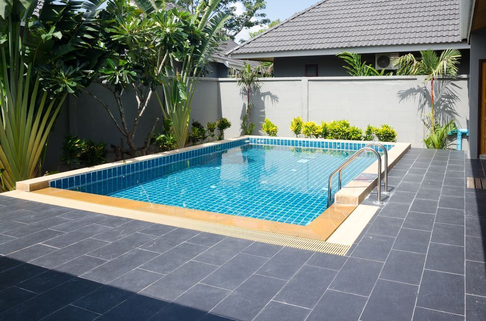 A Large Swimming Pool in the Backyard of a House — Focus On Water In Cannonvale, QLD