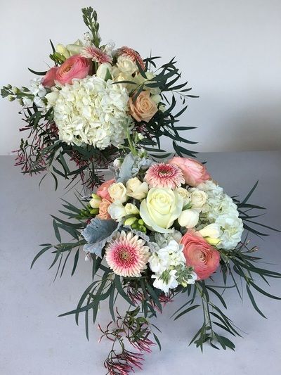 Two bouquets of flowers are sitting on a table.