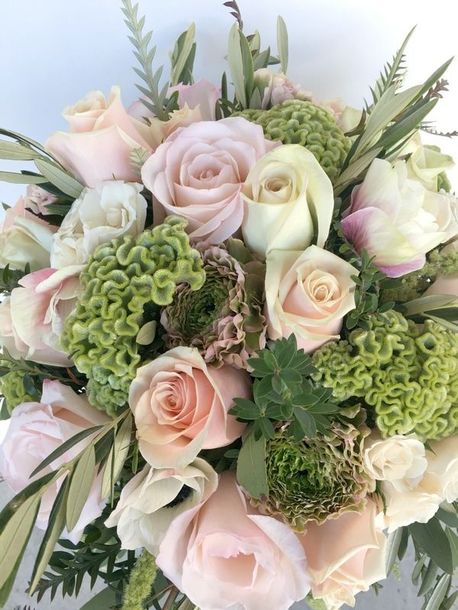 A bouquet of pink and white roses and greenery