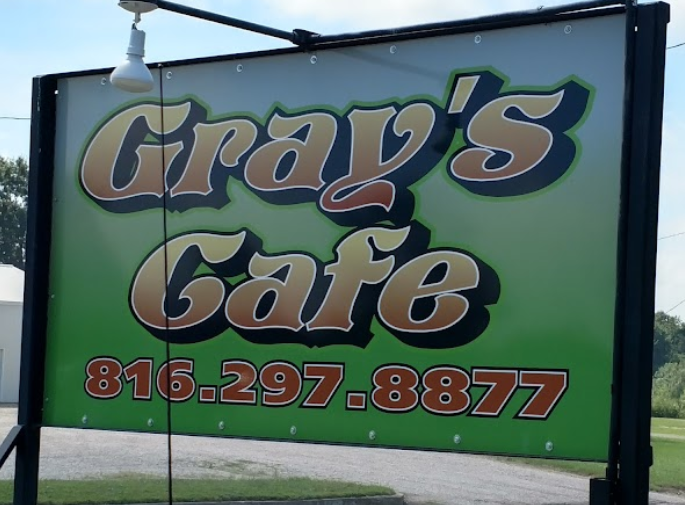 A sign for gray 's cafe with a phone number