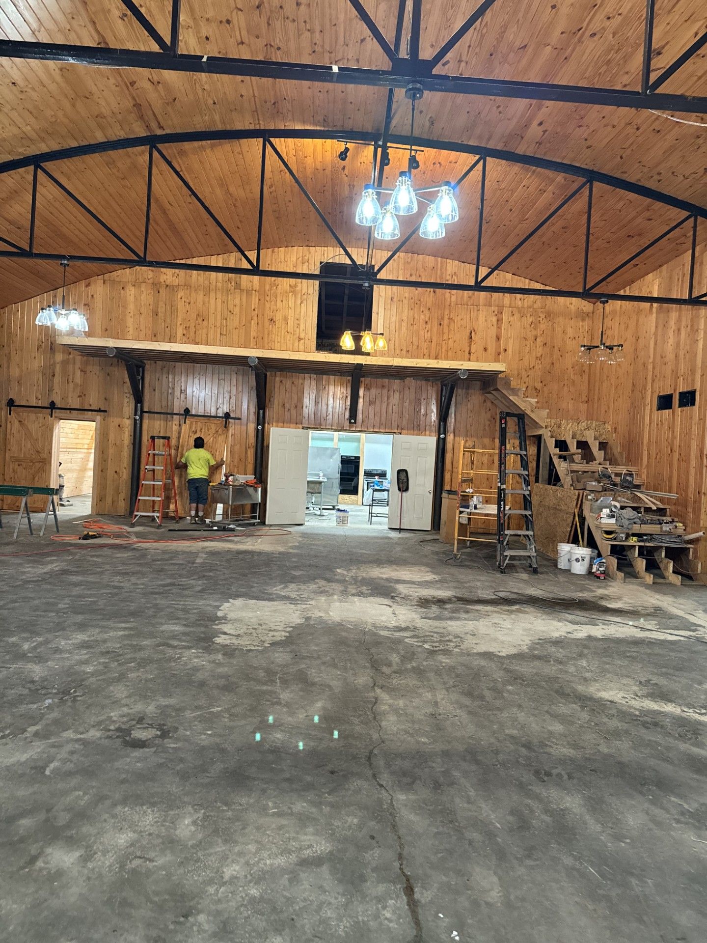 A large room with a wooden ceiling and stairs