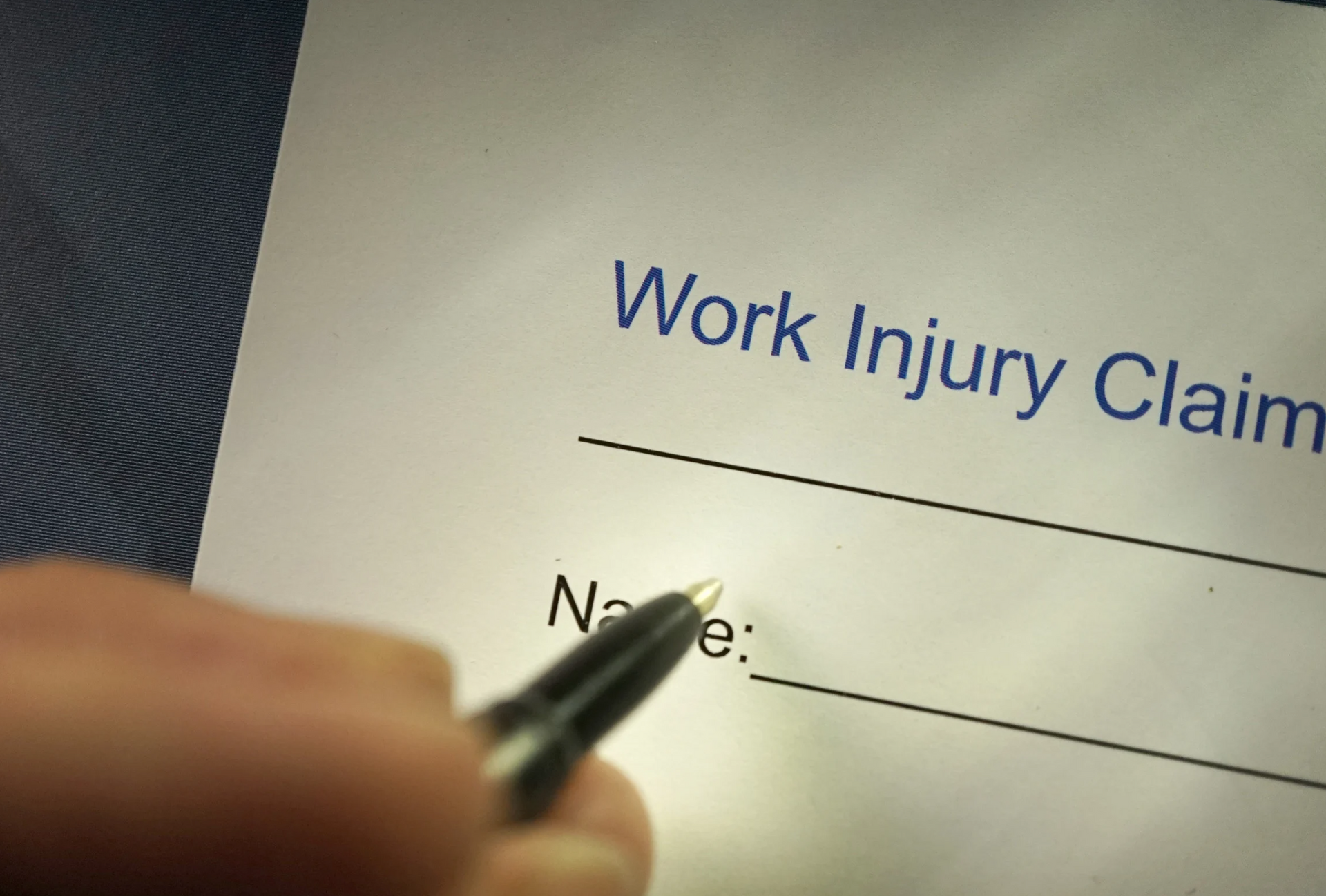 A person's hand holding a pen above a