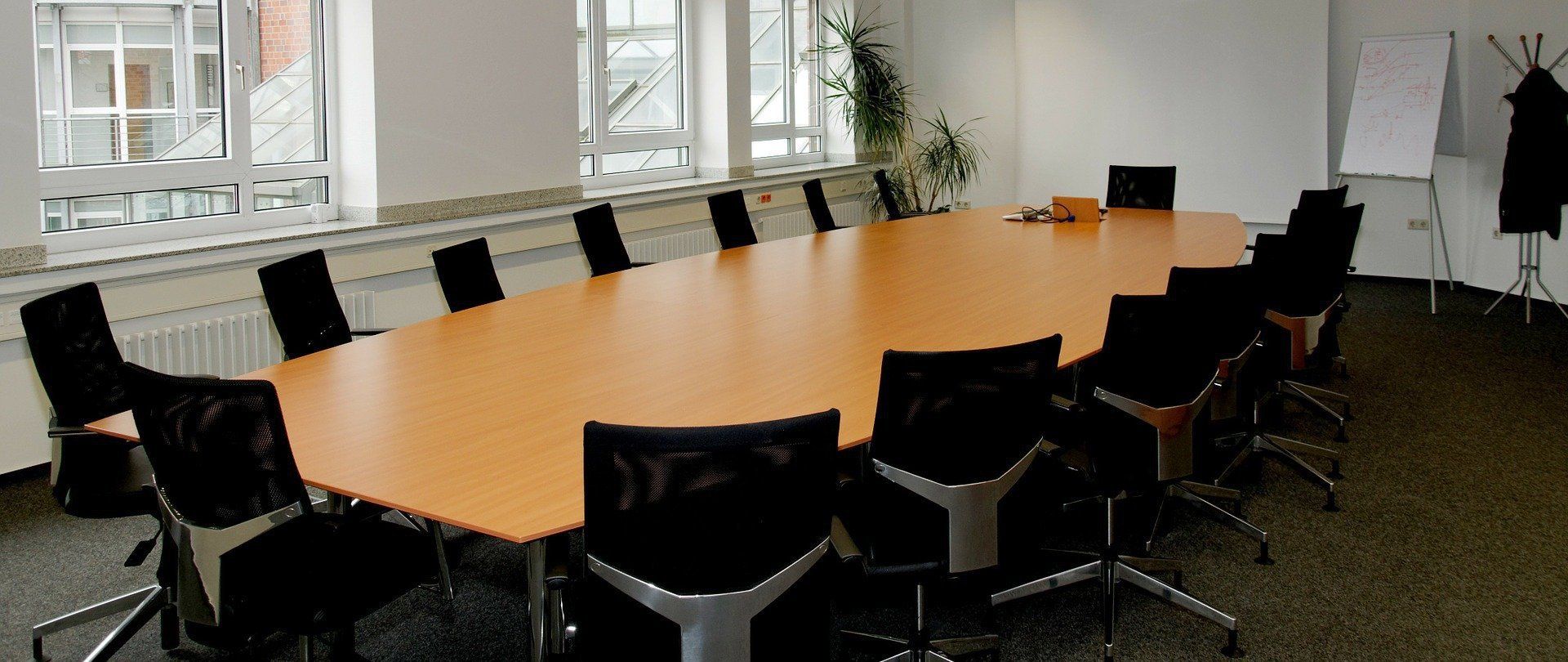 A conference room with a long table and chairs