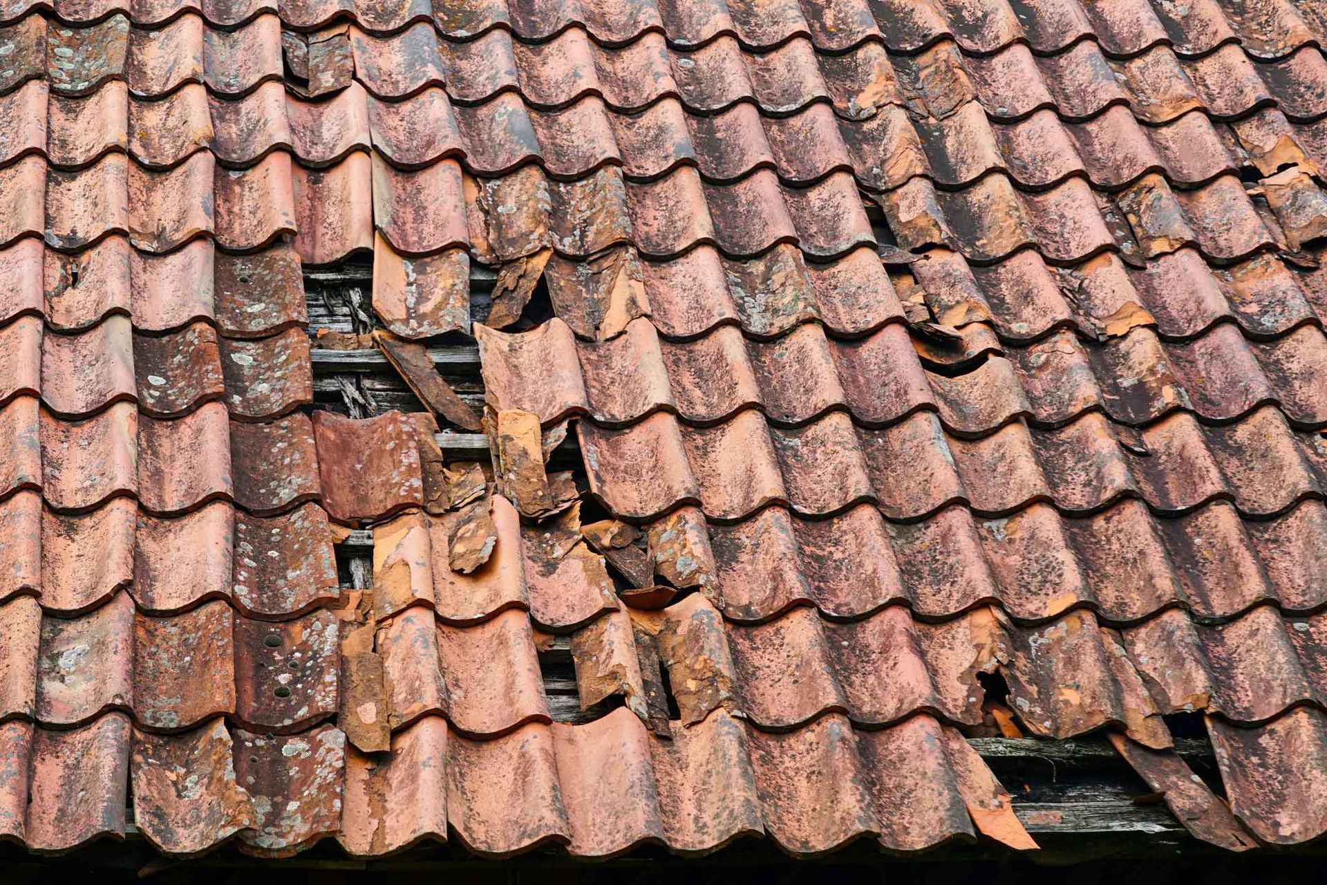 A damaged tile roof. A damaged tile roof.