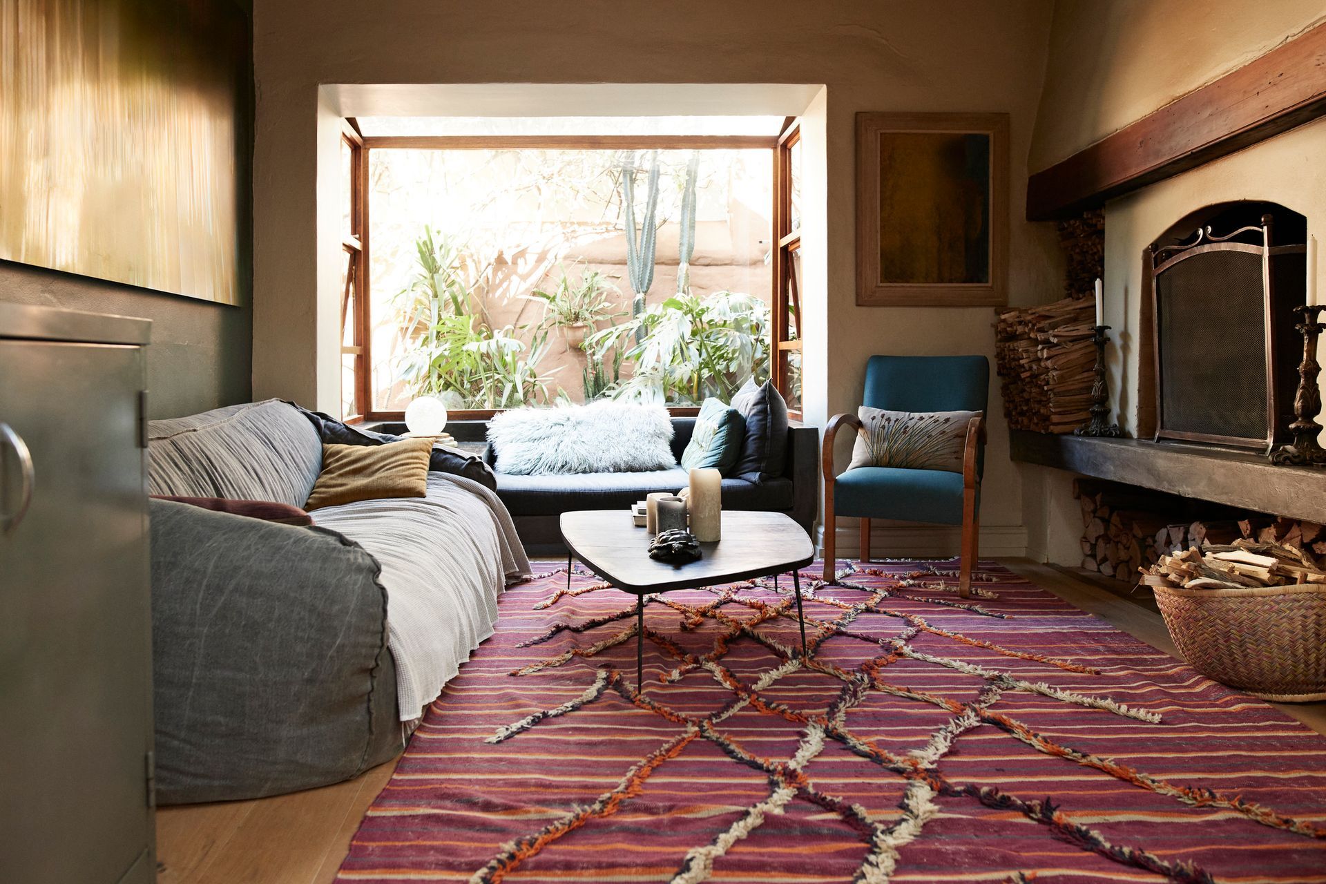 Light grey carpet with a white chair and a pink pillow, near a fireplace.