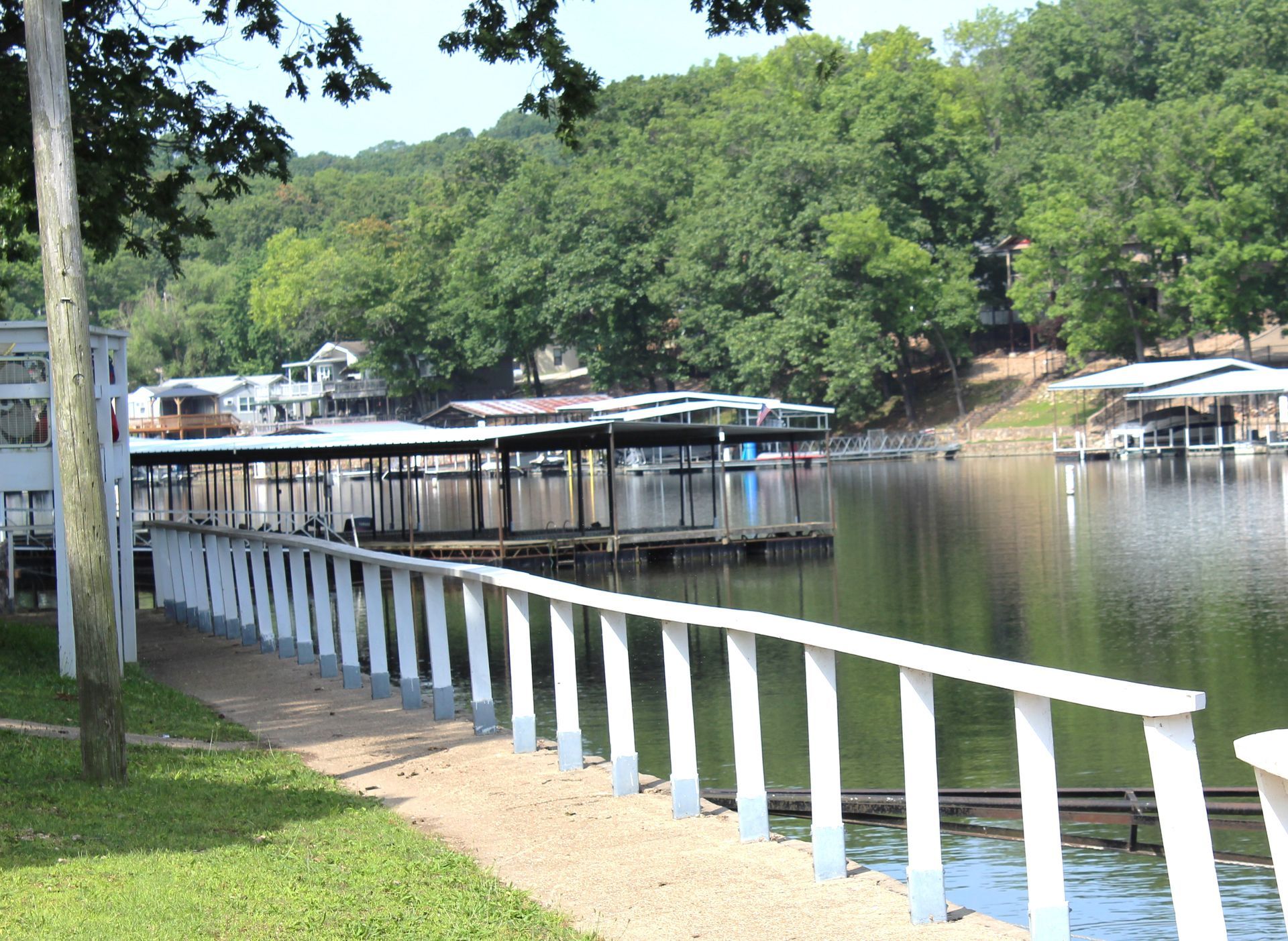 A dock with a white railing overlooking a lake
