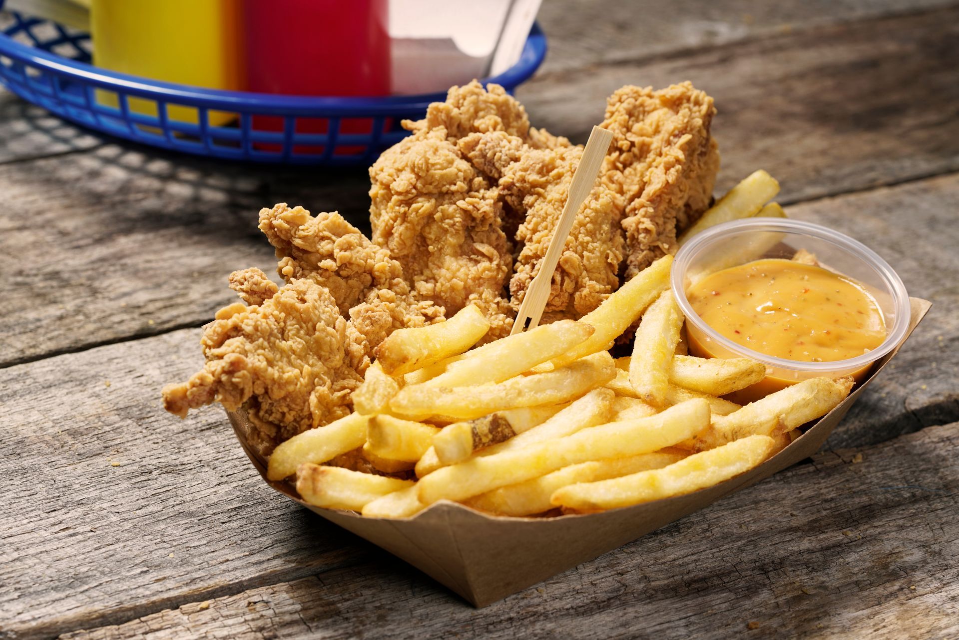 French toast is being poured with syrup on a plate.