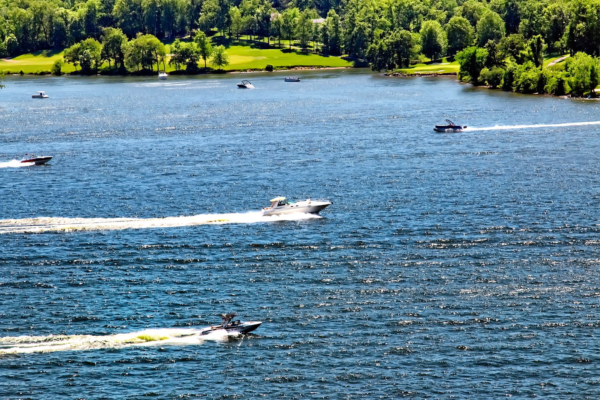 A group of boats are floating on a lake.