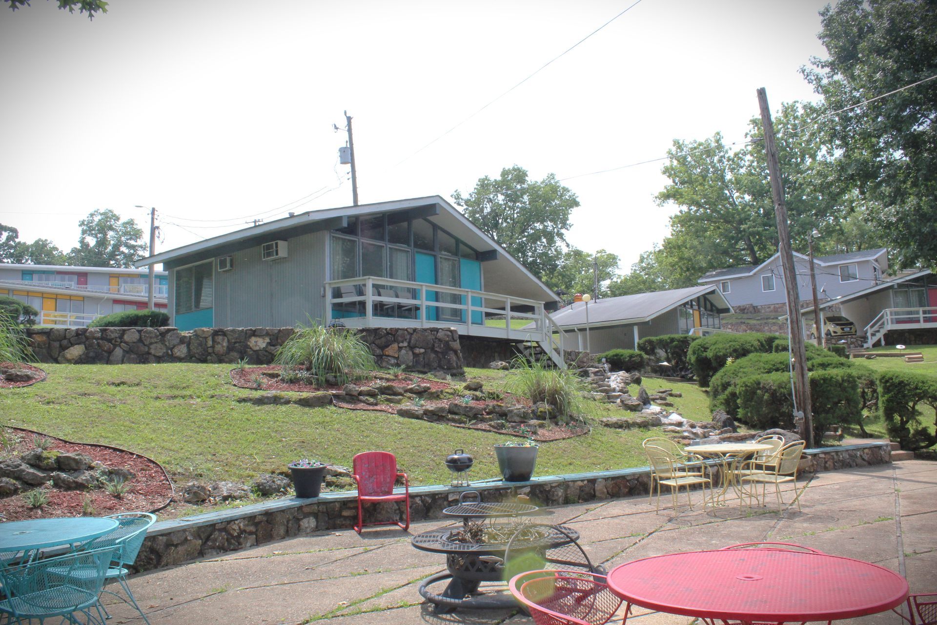 A patio area with tables and chairs in front of a house