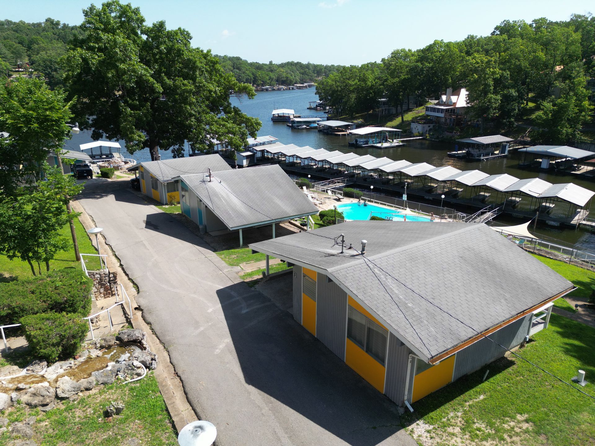 An aerial view of a row of houses next to a lake