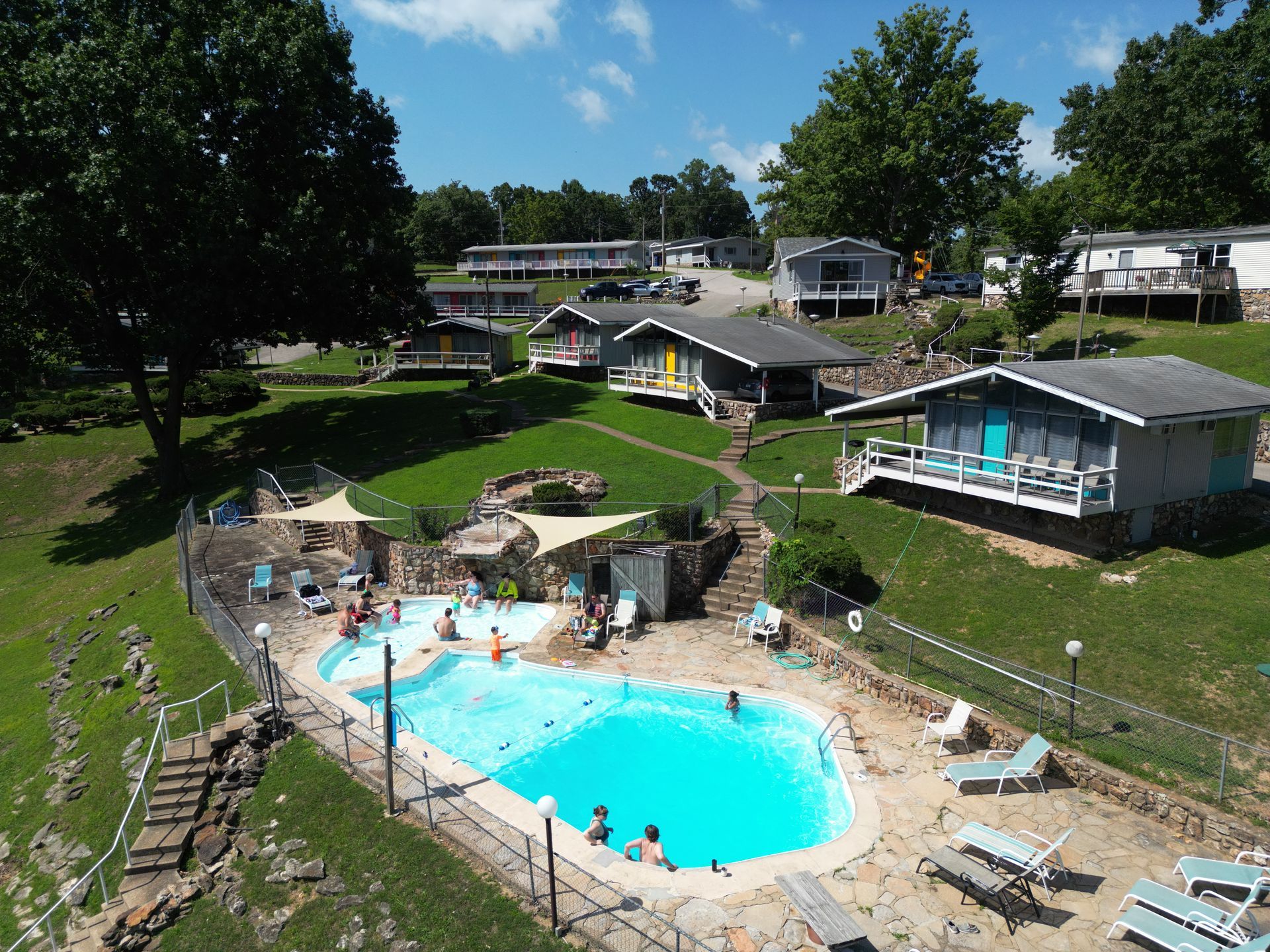 A group of people are swimming in a large swimming pool