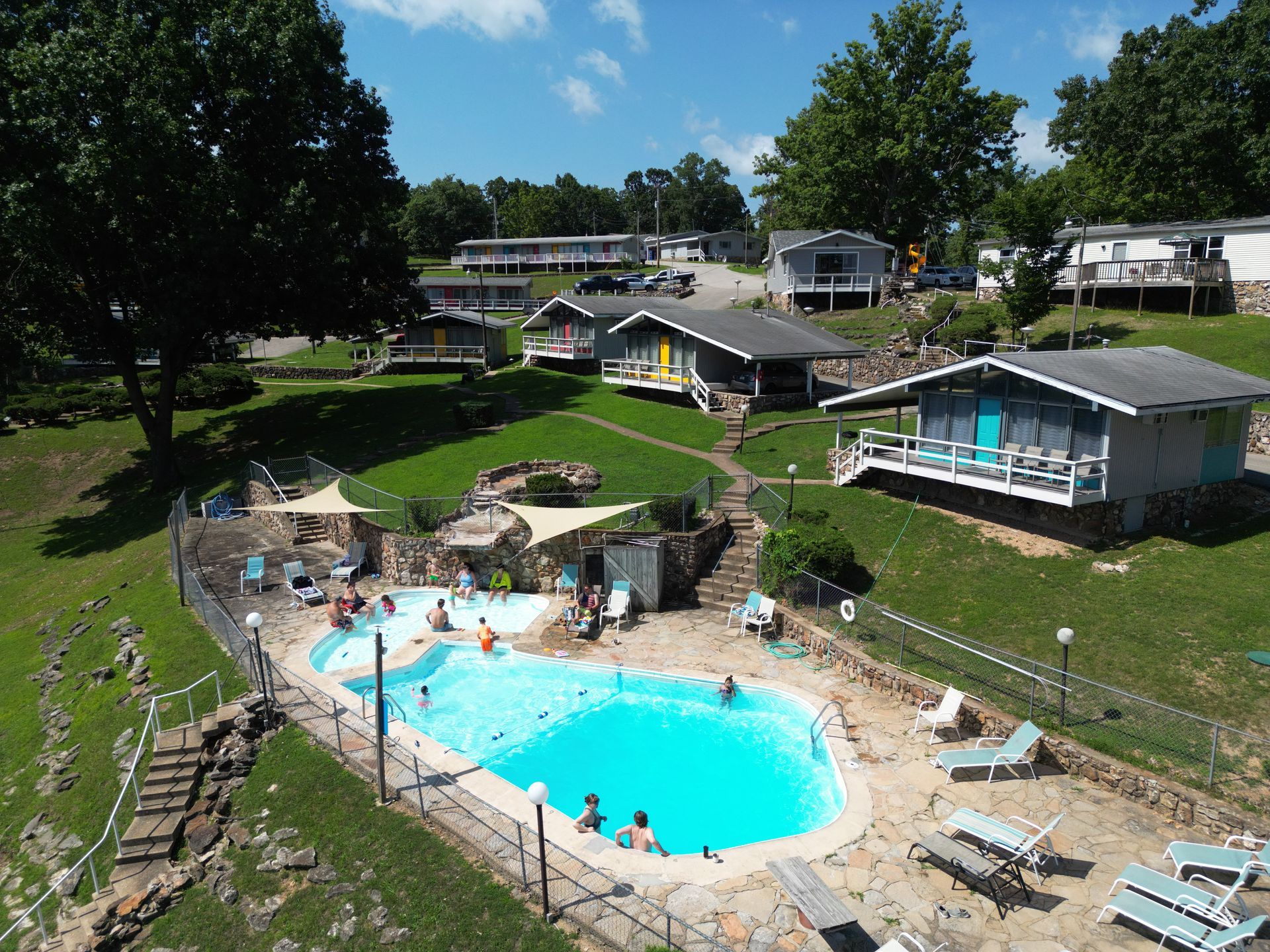 An aerial view of a resort with a large swimming pool