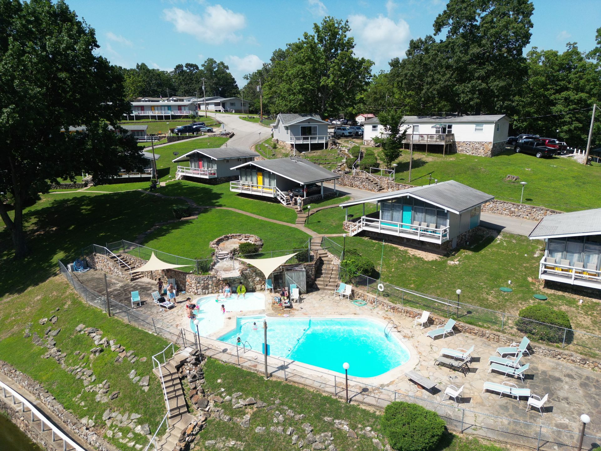 An aerial view of a resort with a large swimming pool