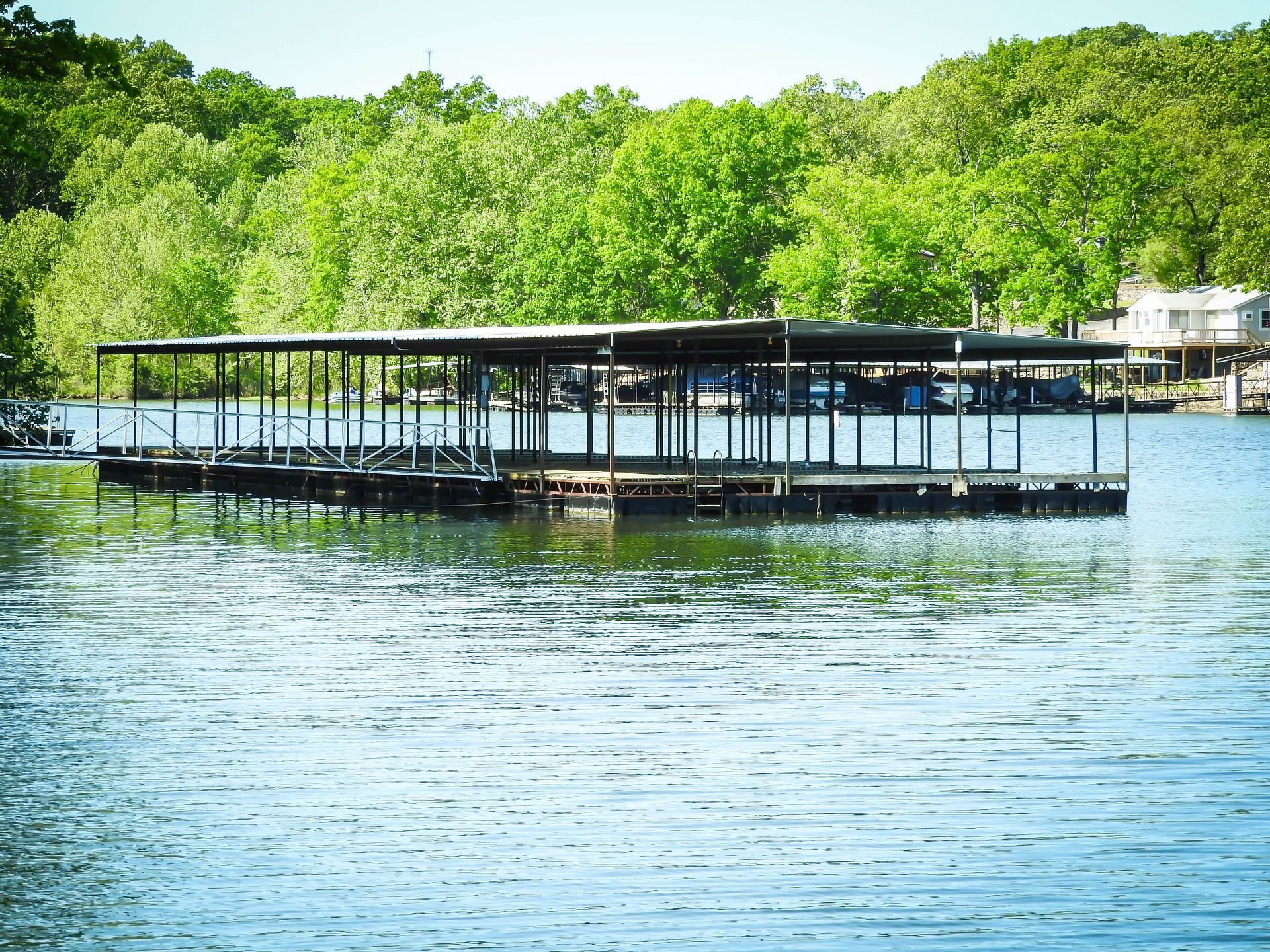 A dock on a lake with trees in the background
