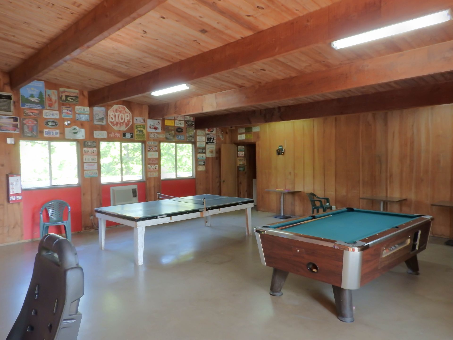 A pool table and ping pong table are in a room.