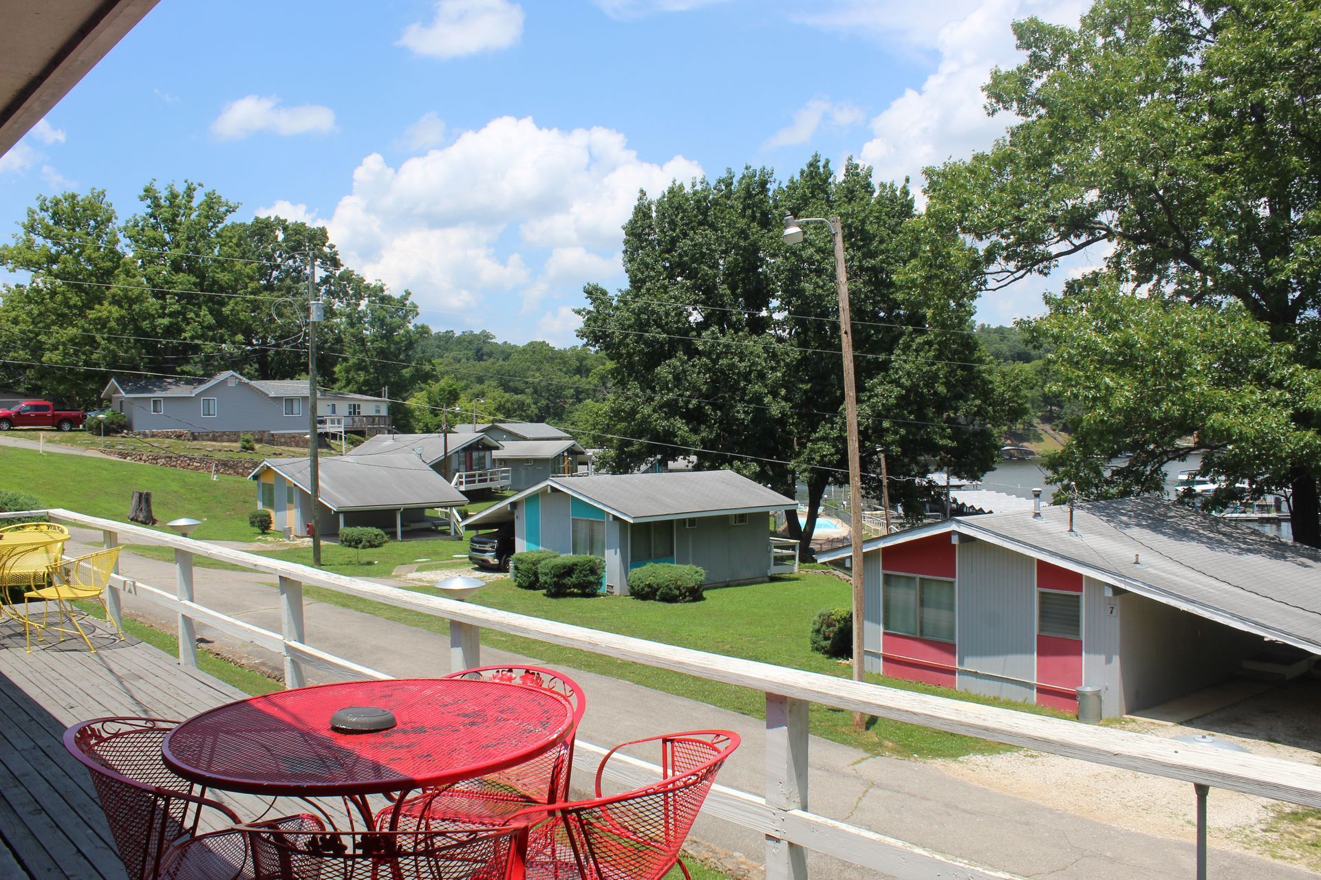 A table and chairs on a balcony overlooking a small town