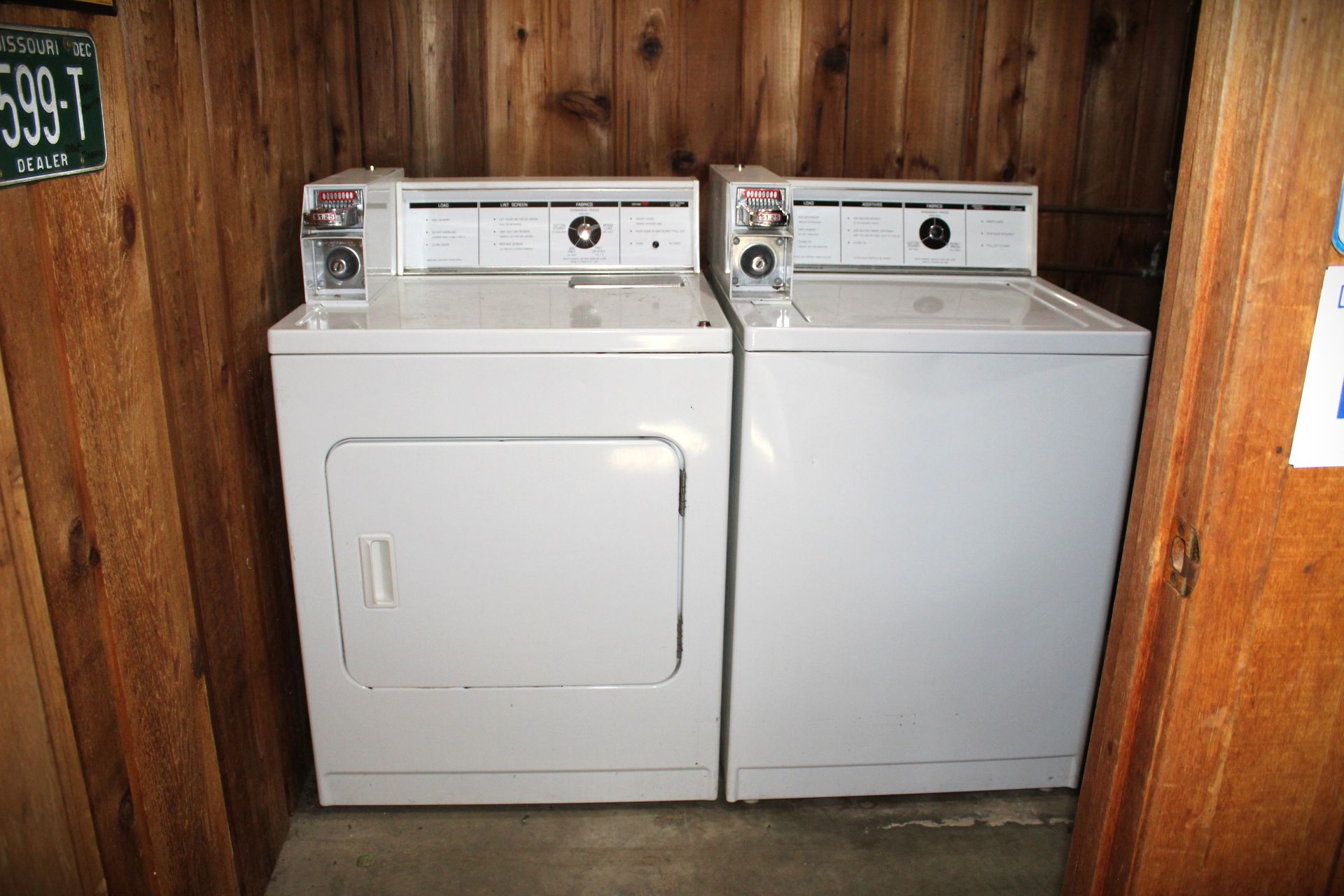 A washer and dryer are sitting next to each other in a laundry room.