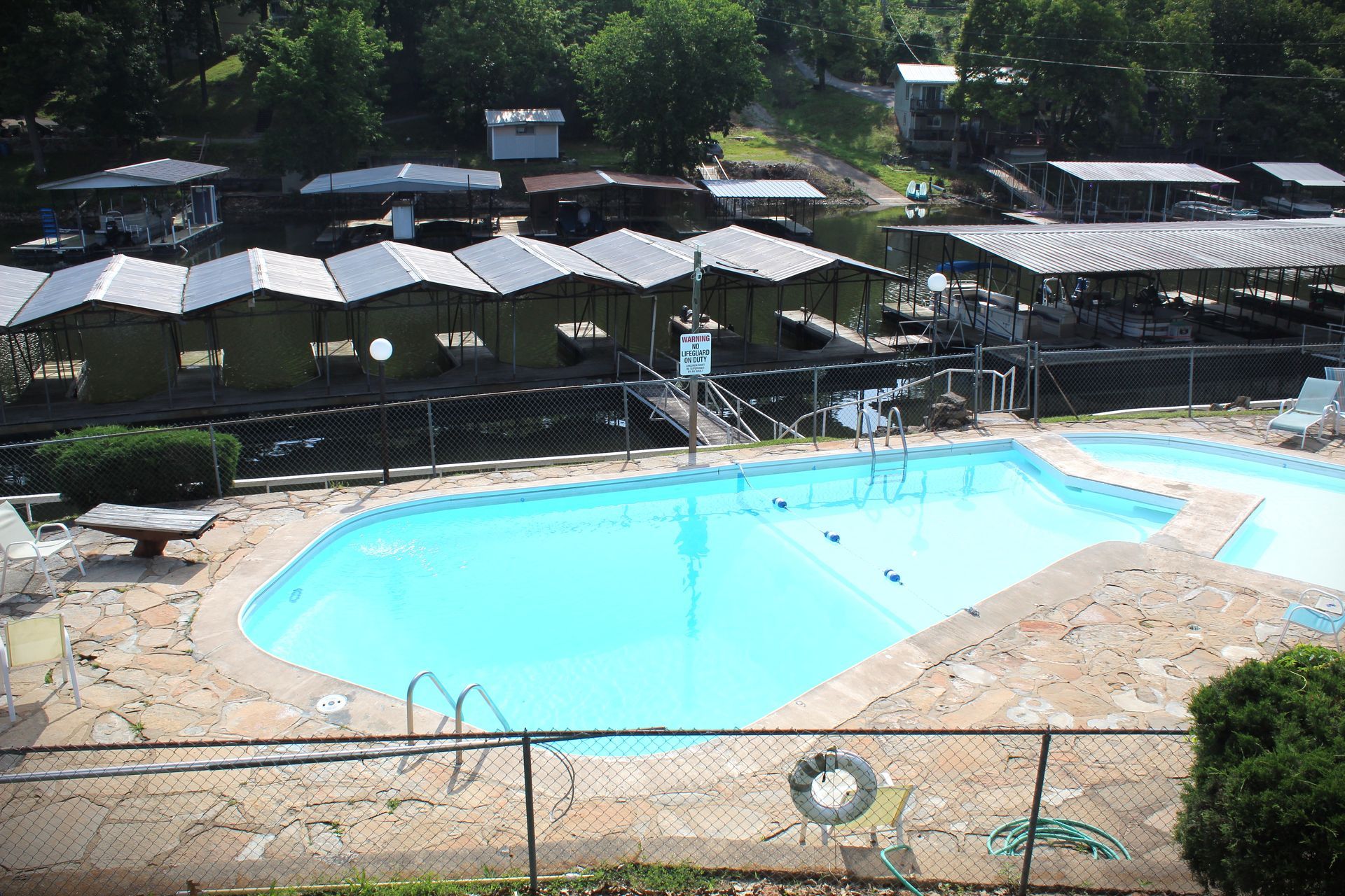 A large swimming pool surrounded by umbrellas and chairs