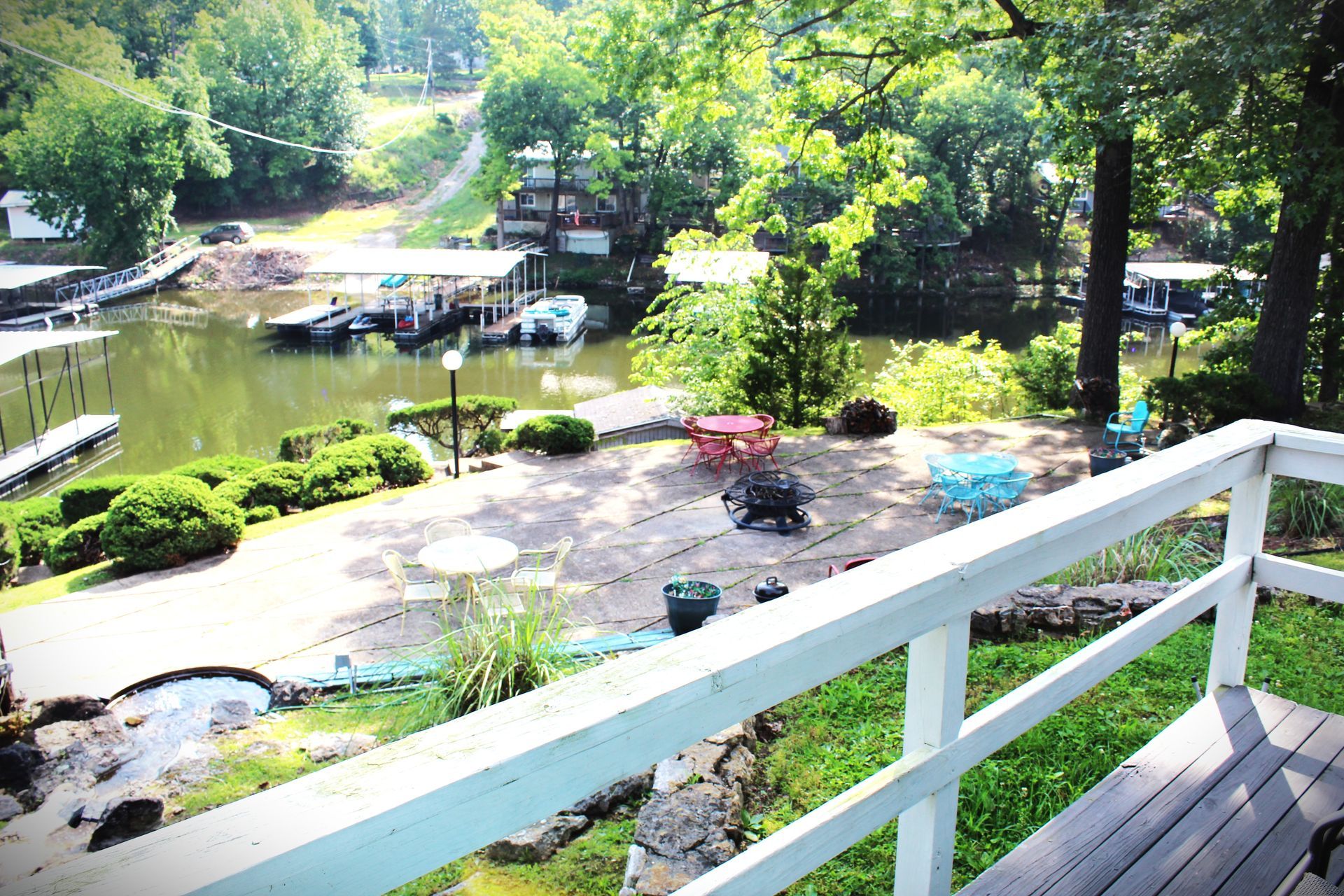 A view of a lake from a deck with a white railing