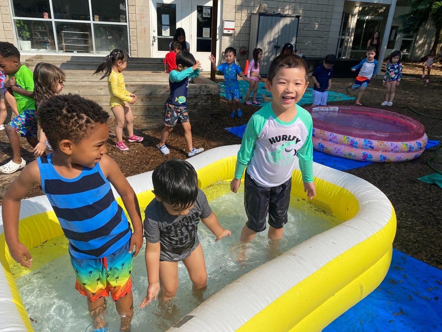 A group of children are playing in an inflatable pool.