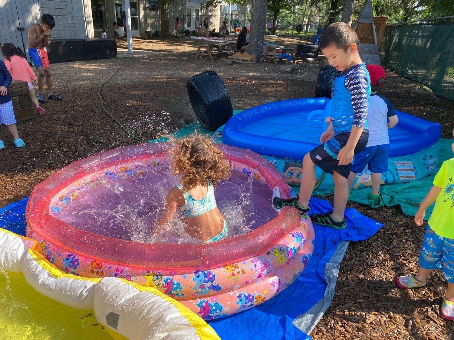 A group of children are playing in an inflatable pool.