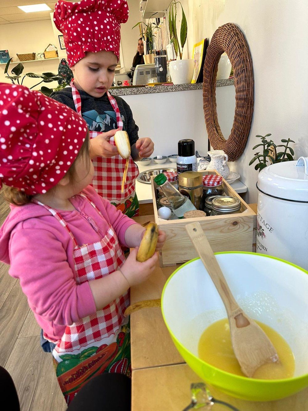 A boy and a girl are preparing food in a kitchen.