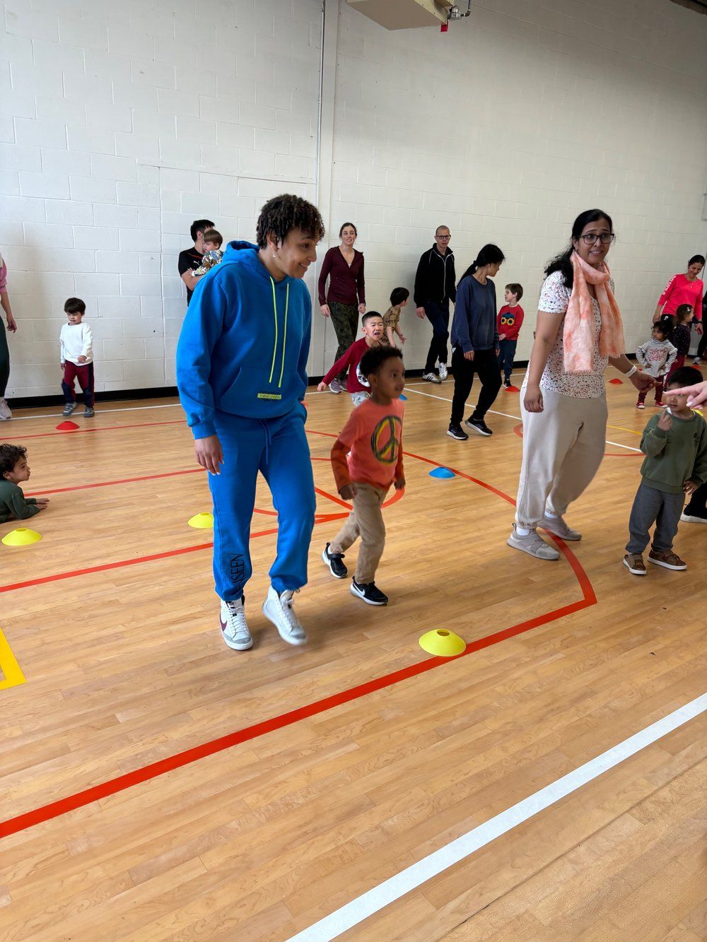 A group of people are playing a game in a gym.